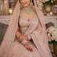 Modern Indian bride wearing a pastel bridal lehenga with kundan jewellery and elegant dupatta draping