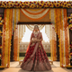  Indian bride in a red embroidered lehenga at a grand floral mandap — celebrity bridal style inspiration by FZO